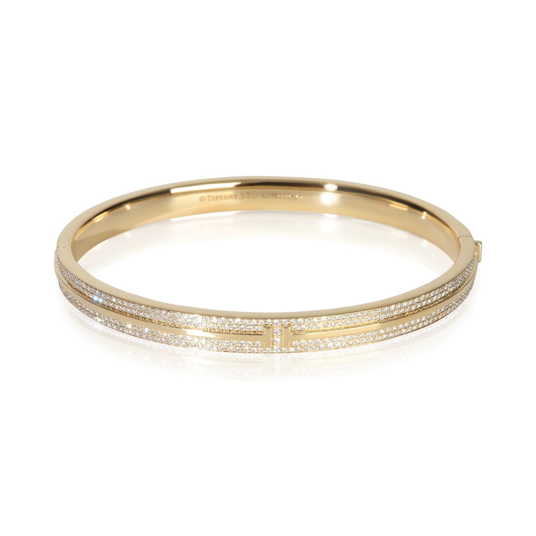 Tiffany T Hinged Bangle 18k Yellow Gold Diamond Bracelet: Tiffany T Hinged Bangle 18k Yellow Gold Diamond Bracelet This pre-owned Tiffany & Co. Tiffany T Hinged Bangle Bracelet is crafted from 18k yellow gold and features round brilliant diamonds totaling 0.