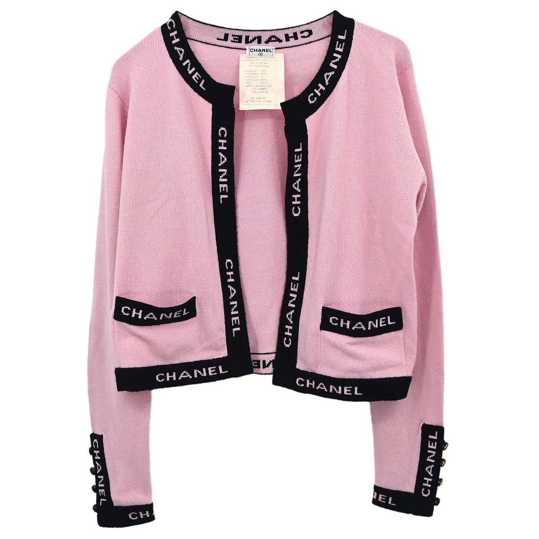 CHANEL Pink Cashmere Knit Button Logo Women Cardigan Size 42: CHANEL Pink Cashmere Knit Button Logo Women Cardigan Size 42 This vintage Chanel cardigan is crafted from 100% cashmere in a soft pink hue. Designed with long sleeves and a regular fit, it features a 