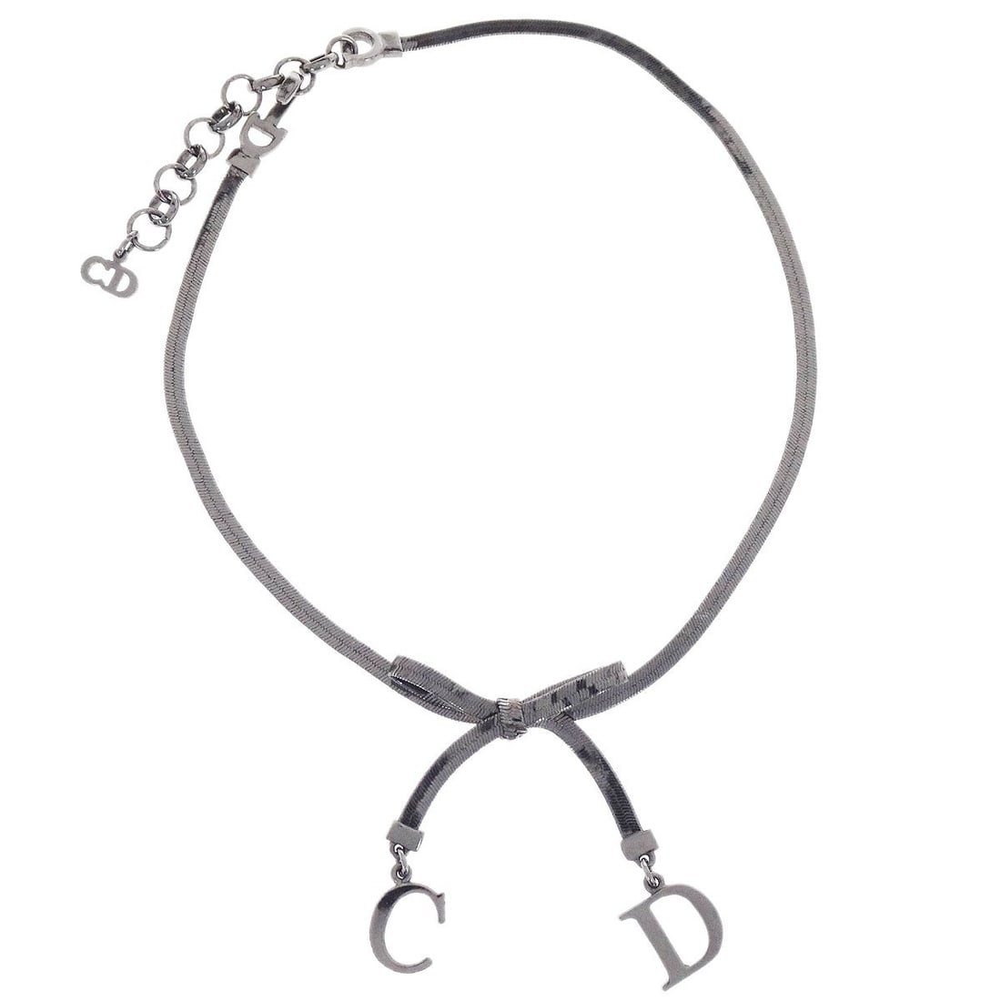 Dior Vintage Silver Tone Pendant Charm Necklace: Dior Vintage Silver Tone Pendant Charm Necklace This vintage Christian Dior necklace features a silver-tone pendant in a charm style. The piece is designed with a classic pendant look and shows reason