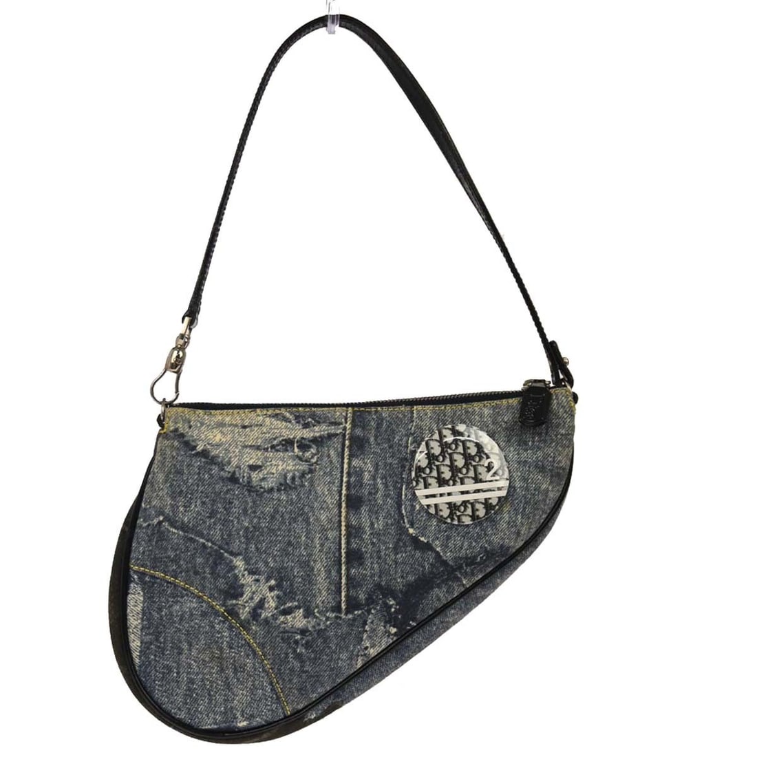 Dior Saddle Bag Small Blue Denim Canvas Handbag with 7 Inch Handle Drop: Dior Saddle Bag Small Blue Denim Canvas Handbag with 7 Inch Handle Drop This Christian Dior Saddle handbag features a blue denim print on canvas, offering a stylish and recognizable silhouette. The sm