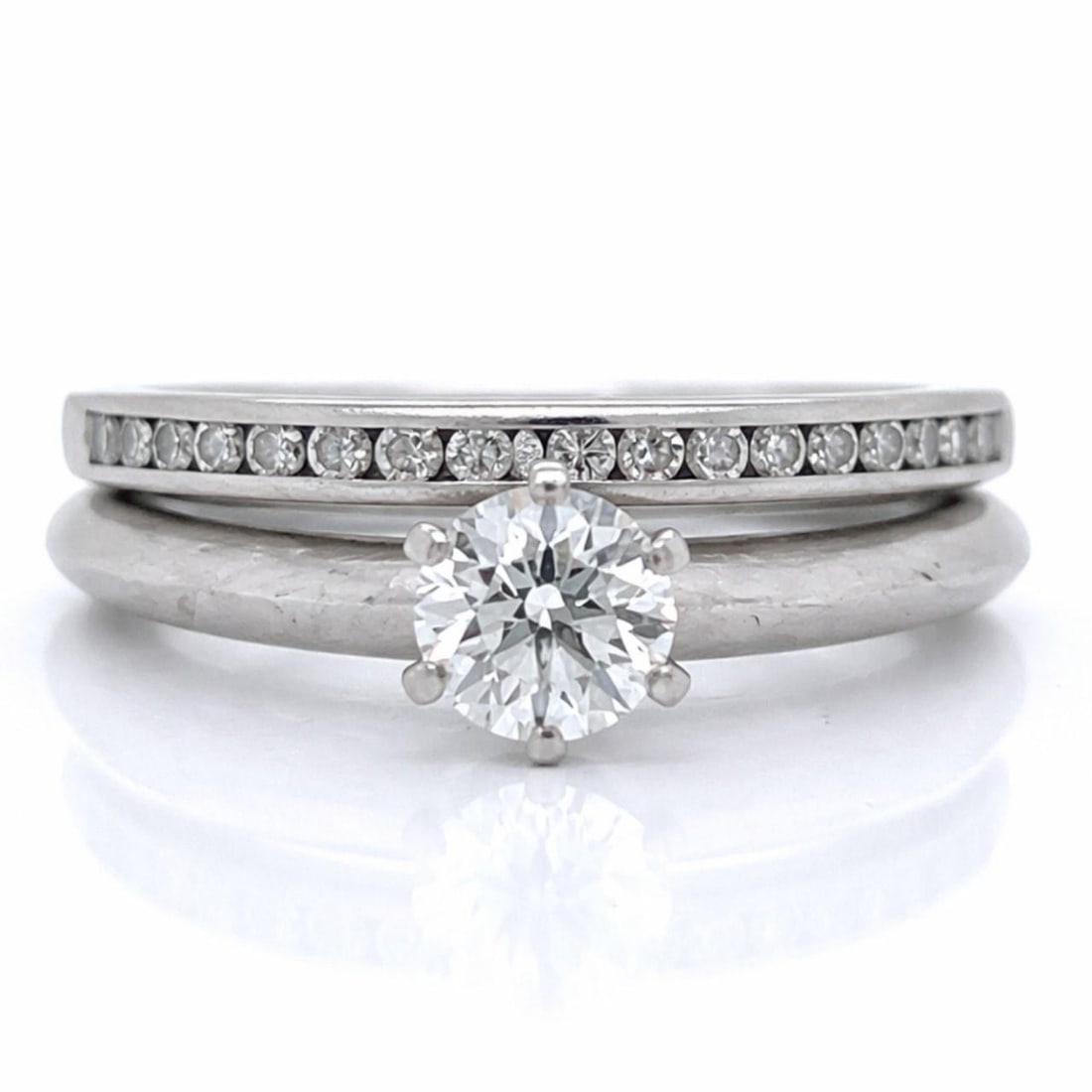 Tiffany & Co. Platinum Diamond Ring Set with 0.46 Ct Center Stone and 17 Accents: Tiffany & Co. Platinum Diamond Ring Set with 0.46 Ct Center Stone and 17 Accents This Tiffany & Co. platinum ring set features an engagement and anniversary ring, weighing a total of 8.0 grams. The se