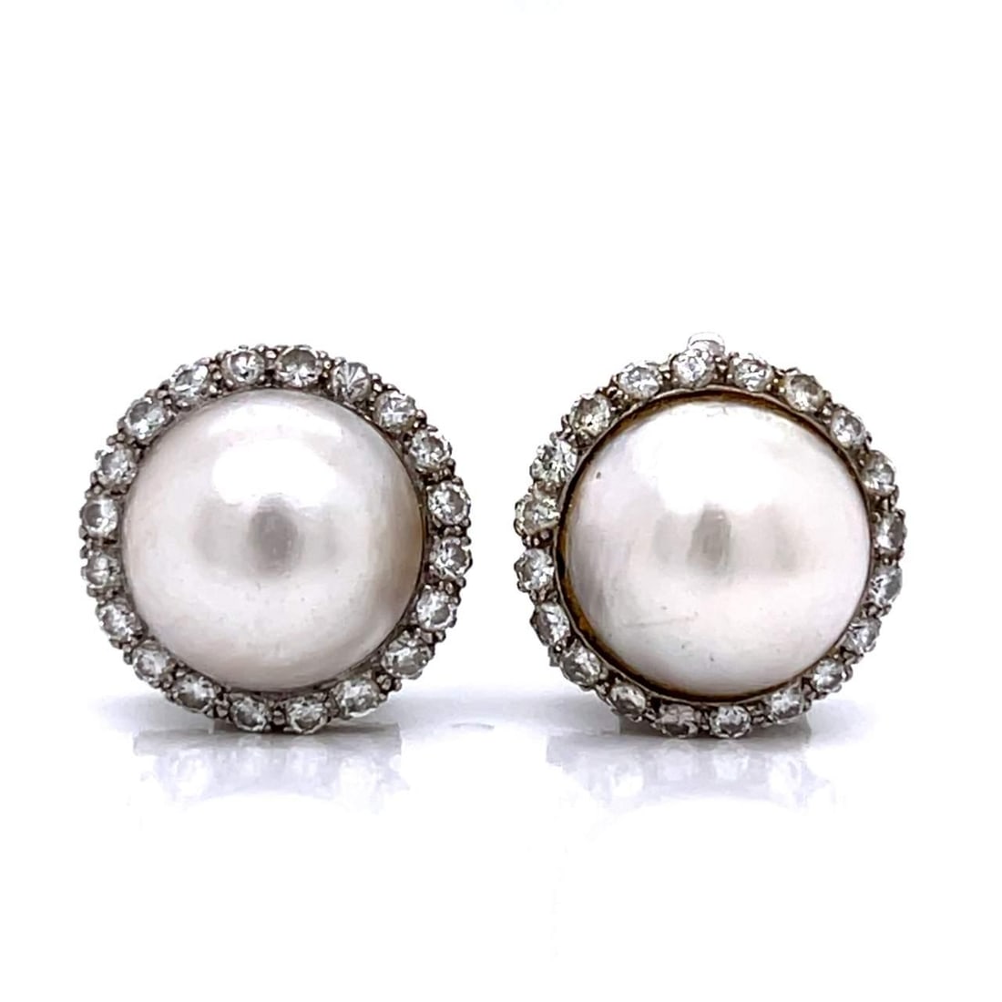 1950s Platinum Mabe Pearl Diamond Earrings 1.60 Ct Vintage Elegance: 1950s Platinum Mabe Pearl Diamond Earrings 1.60 Ct Vintage Elegance These exquisite 1950's earrings are crafted in platinum and feature stunning Mabe pearls and sparkling diamonds. Each earring is set