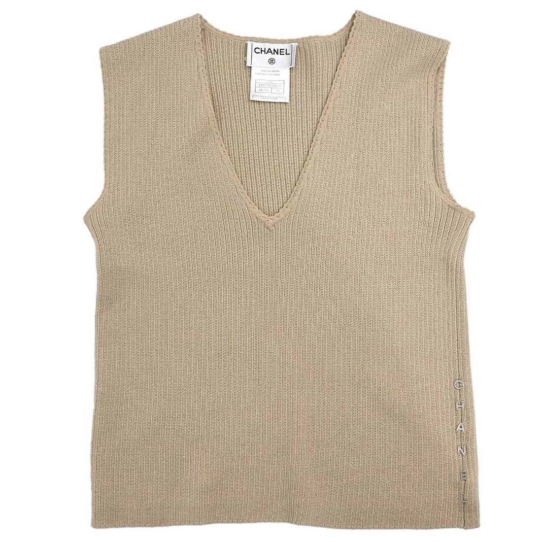 Chanel Beige Wool Knit Sleeveless V Neck Top Size 38: Chanel Beige Wool Knit Sleeveless V Neck Top Size 38 This Chanel sleeveless knit vest top features a classic V-neck design in beige. Made from 100% wool, it offers a regular fit and is ideal for casua