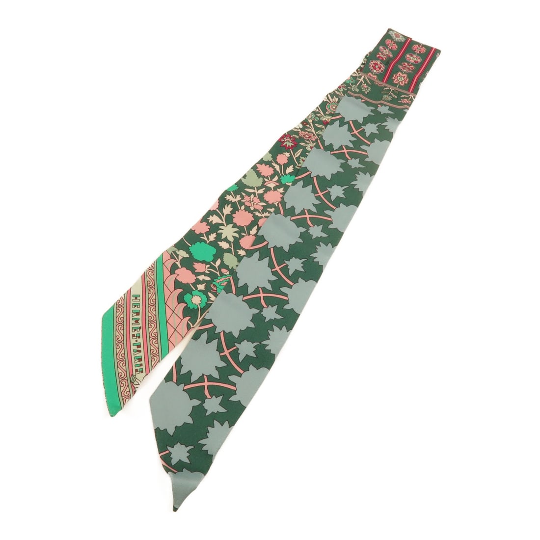 Hermes Green Silk Twilly Scarf: Hermes Green Silk Twilly Scarf This Hermes Twilly scarf is crafted from high-quality silk and features a vibrant green color. Designed for women, this elegant accessory is made in France and showcases