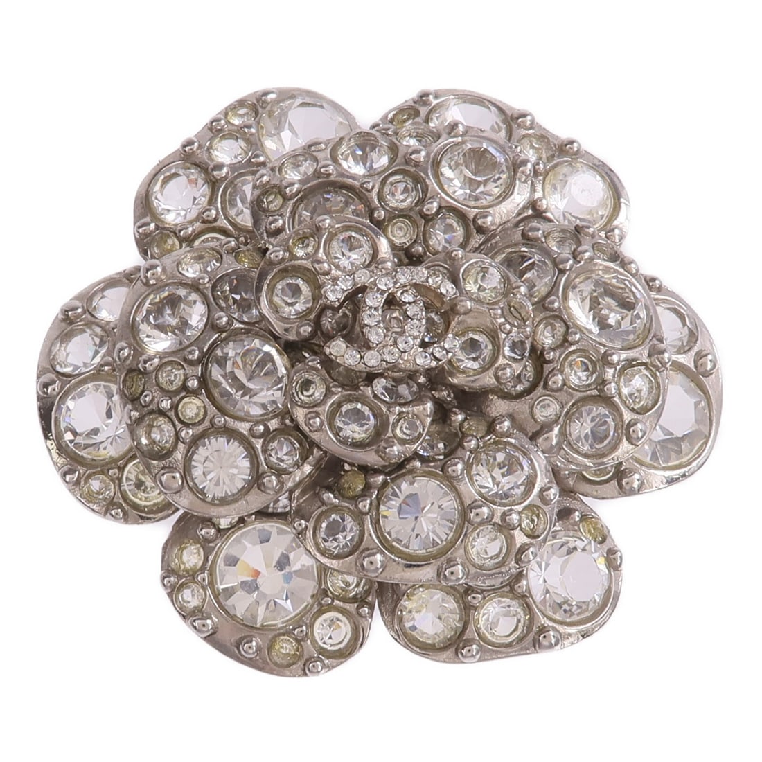 CHANEL Silver Metal CC Brooch: CHANEL Silver Metal CC Brooch This CHANEL brooch features the iconic CC logo in a silver-tone metal finish. Designed for women, it offers a stylish accent to any outfit. The brooch does not include an