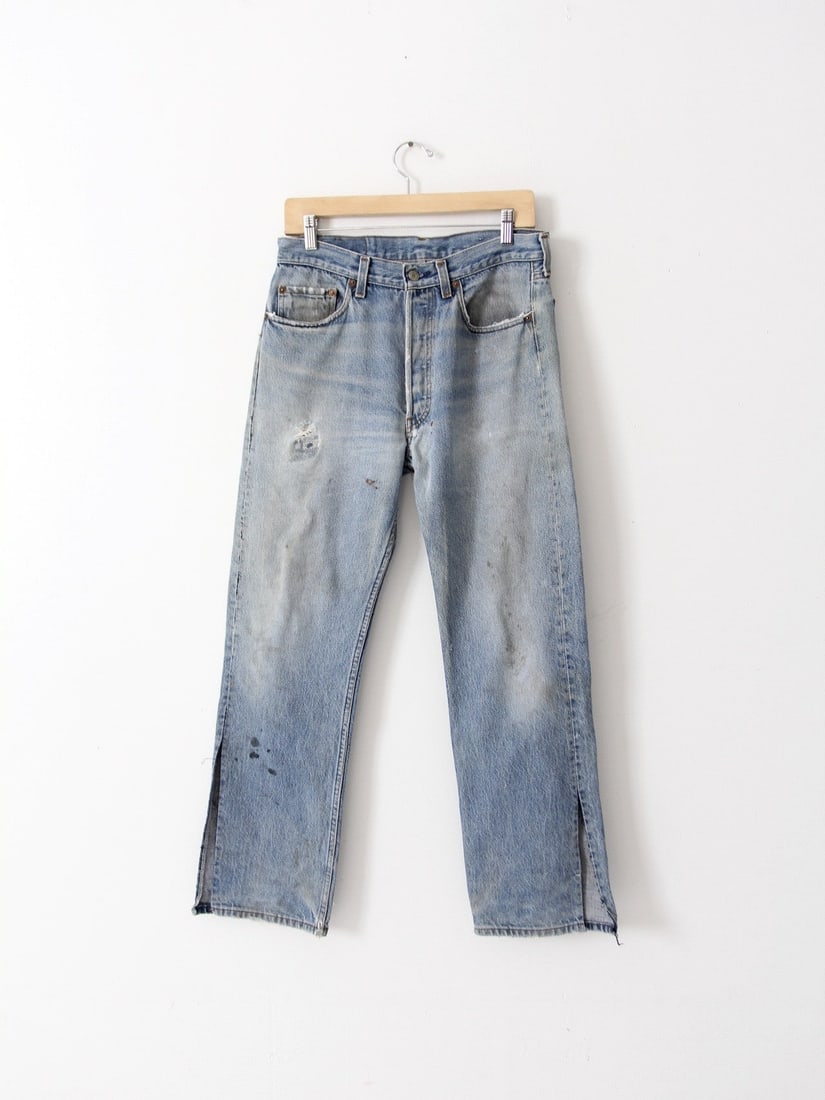 Vintage Levis 501 Distressed Jeans with Side Slits 32 x 30: Vintage Levis 501 Distressed Jeans with Side Slits 32 x 30 Discover a unique pair of vintage Levis 501 jeans, showcasing a distressed look that embodies classic style. These jeans feature a high waist