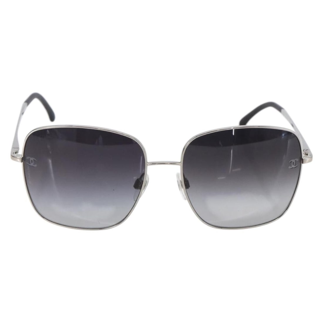 Black Plastic Sunglasses for Women by Chanel with Logo: Black Plastic Sunglasses for Women by Chanel with Logo These Chanel logo sunglasses for women feature a black plastic frame crafted in Italy. The pre-owned eyewear is in good condition with slight sur
