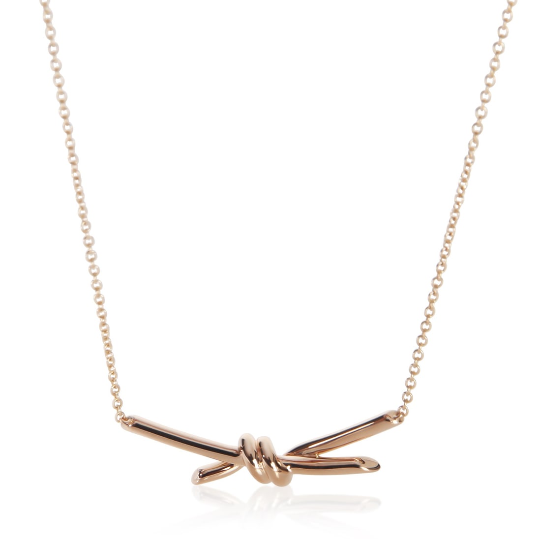Tiffany Knot 18k Rose Gold Pendant by Tiffany & Co.: Tiffany Knot 18k Rose Gold Pendant by Tiffany & Co. This pre-owned Tiffany & Co. Knot Pendant is crafted from 18k rose gold, featuring a spring ring clasp and a delicate pink hue. Part of the Tiffany 
