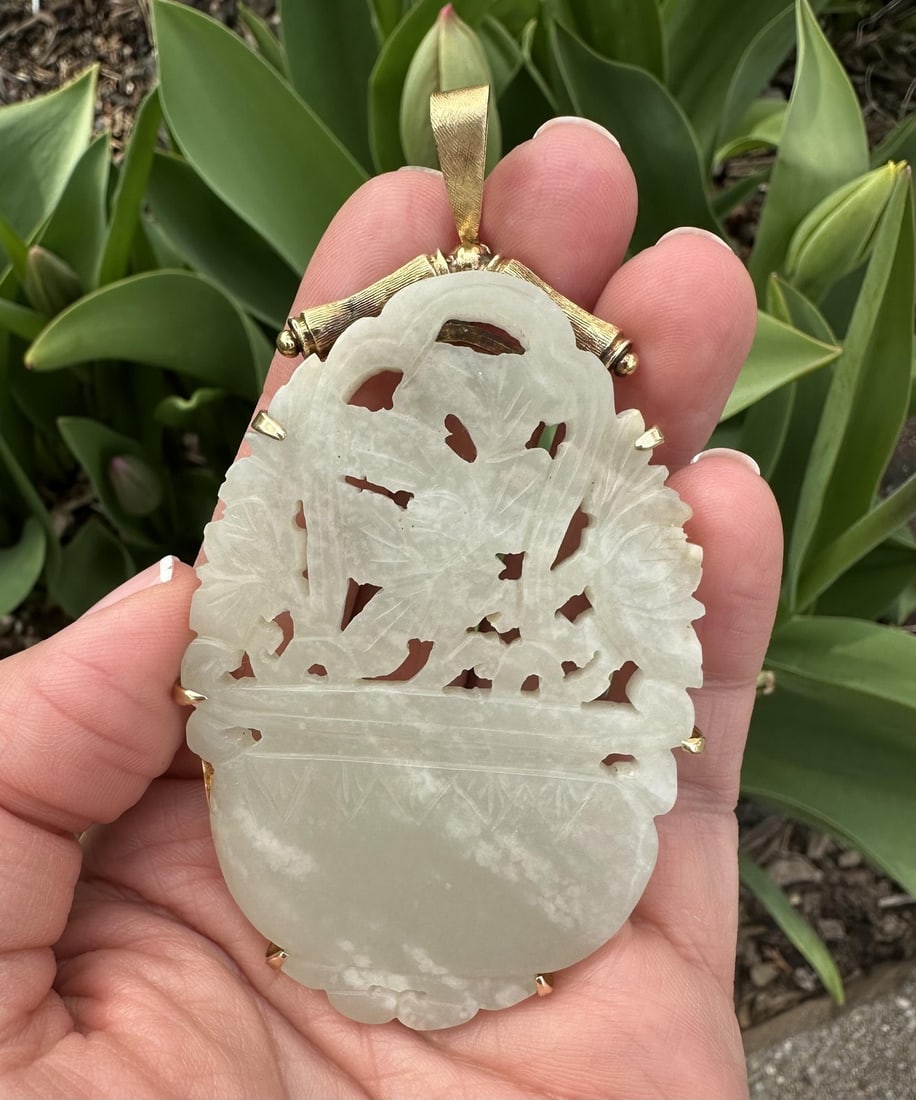 14k Yellow Gold Jade Flower Basket Pendant with Bamboo Frame: 14k Yellow Gold Jade Flower Basket Pendant with Bamboo Frame This exquisite pendant features a large, intricately carved flower basket design made from natural jade, showcasing a pale marbled green co