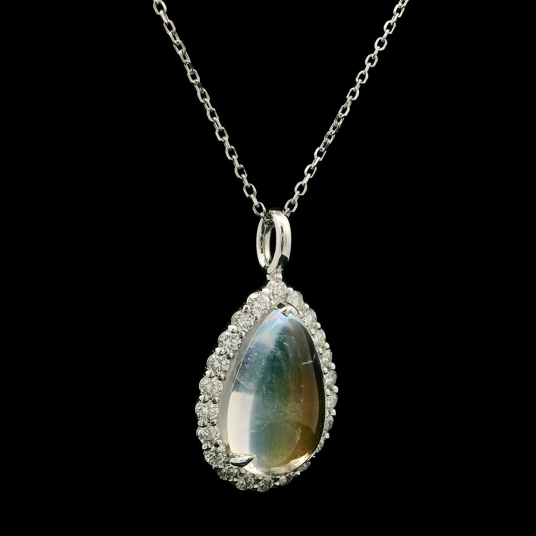 Custom 14k White Gold Blue Moonstone Diamond Teardrop Necklace: Custom 14k White Gold Blue Moonstone Diamond Teardrop Necklace This exquisite necklace features a stunning teardrop pendant crafted from solid 14k white gold. The centerpiece is a natural blue moonsto