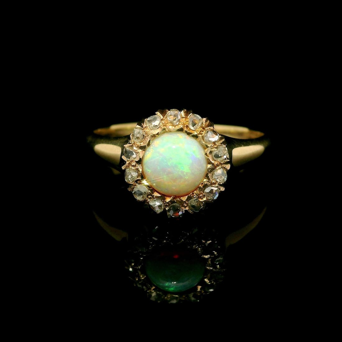 Antique Victorian 14k Yellow Gold Opal Diamond Halo Ring 0.20ctw: Antique Victorian 14k Yellow Gold Opal Diamond Halo Ring 0.20ctw This exquisite Antique Victorian ring features a stunning natural round opal, delicately prong set and showcasing a beautiful play of c