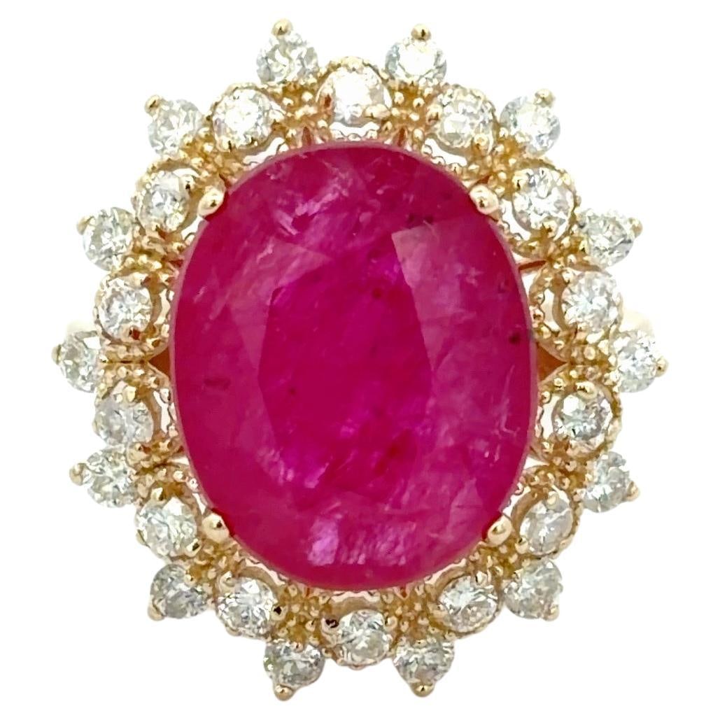 14k Yellow Gold Halo Ring with 8.75ct Oval Ruby and Diamond Accents: 14k Yellow Gold Halo Ring with 8.75ct Oval Ruby and Diamond Accents This striking statement ring features a vivid 8.75 carat oval ruby at its center, surrounded by 28 round brilliant cut diamonds tota