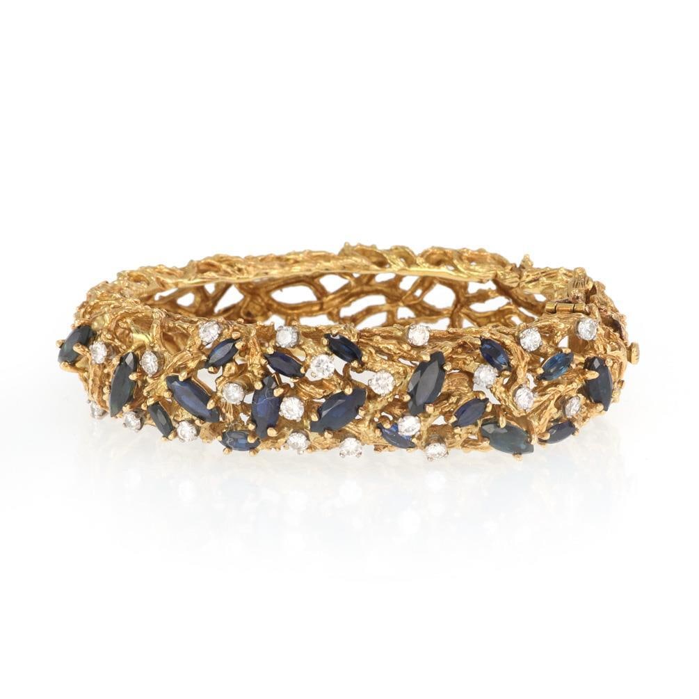 Kutchinsky Vintage 18k Yellow Gold Sapphire Diamond Bangle Bracelet: Kutchinsky Vintage 18k Yellow Gold Sapphire Diamond Bangle Bracelet This stunning vintage bracelet by designer Kutchinsky features an elegant oval dome shape crafted from 18k yellow gold. The bracelet