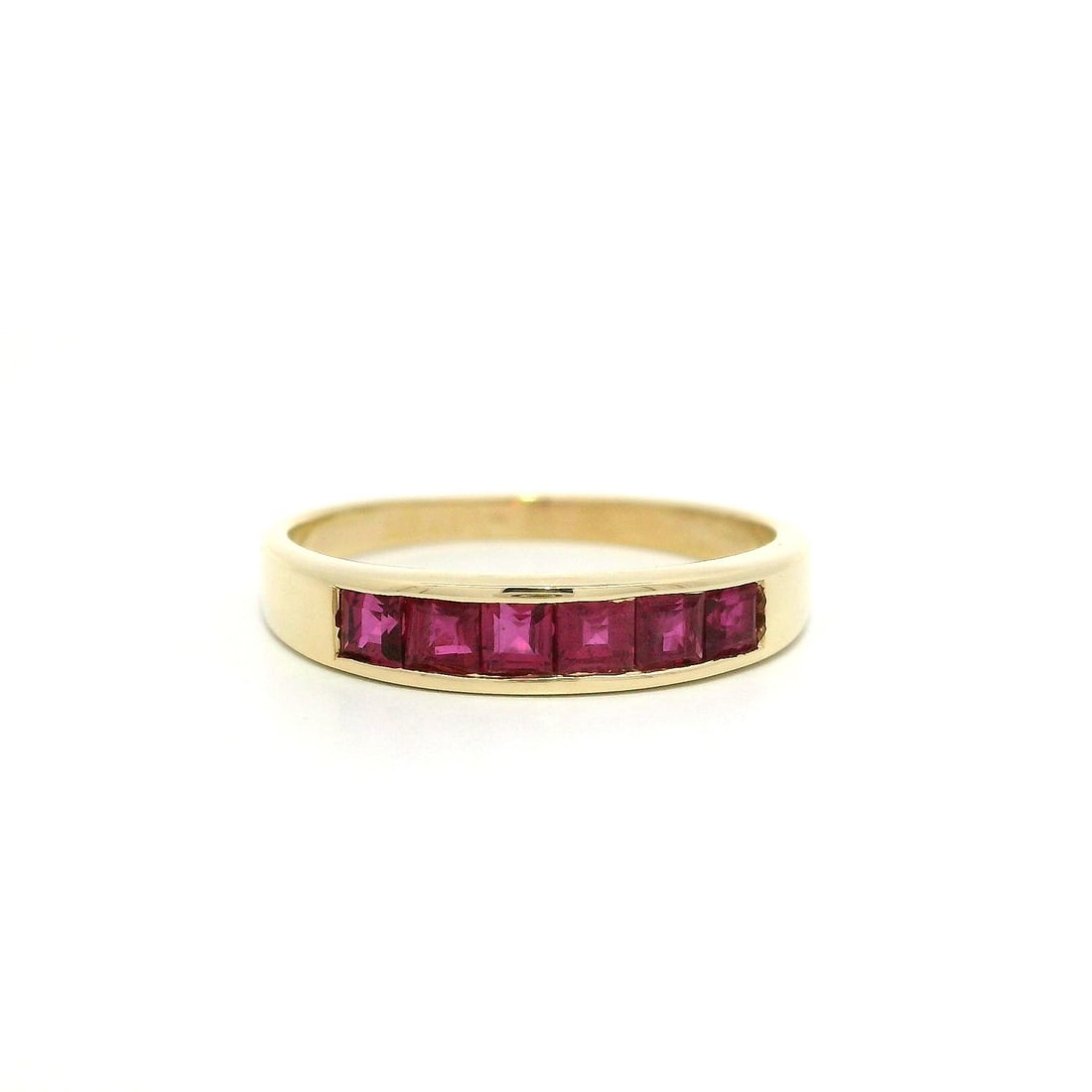 14k Yellow Gold Ruby Channel Set Stackable Band Ring 0.60ctw: 14k Yellow Gold Ruby Channel Set Stackable Band Ring 0.60ctw This exquisite stackable band ring features a stunning design crafted from solid 14k yellow gold. The ring showcases six natural genuine ru