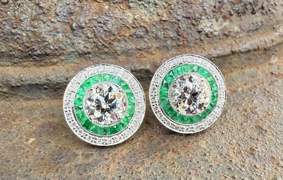 GIA Certified Diamond and Emerald Stud Earrings in 18k White Gold: GIA Certified Diamond and Emerald Stud Earrings in 18k White Gold These exquisite stud earrings feature Old European circular cut natural diamonds at the center, each certified by GIA. Surrounding the