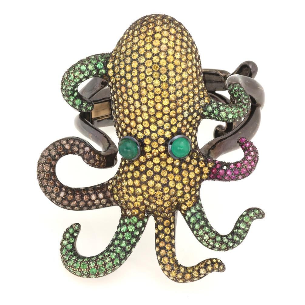Unique 30.50ct 18k Gold Black Rhodium Squid Bracelet with Sapphires and Emeralds: Unique 30.50ct 18k Gold Black Rhodium Squid Bracelet with Sapphires and Emeralds This exquisite bracelet showcases a unique squid design, intricately crafted in black rhodium 18k gold. The squid is ad