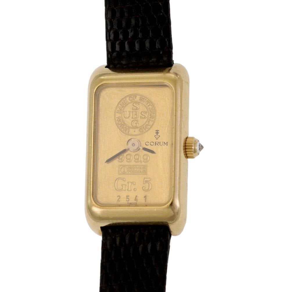 Corum 18k Gold Ladies Watch with 5g 999.9 Fine Gold Ingot Dial: Corum 18k Gold Ladies Watch with 5g 999.9 Fine Gold Ingot Dial Experience elegance with this exquisite Corum ladies wristwatch featuring a stunning 5-gram 999.9 fine gold ingot dial. The watch showcas