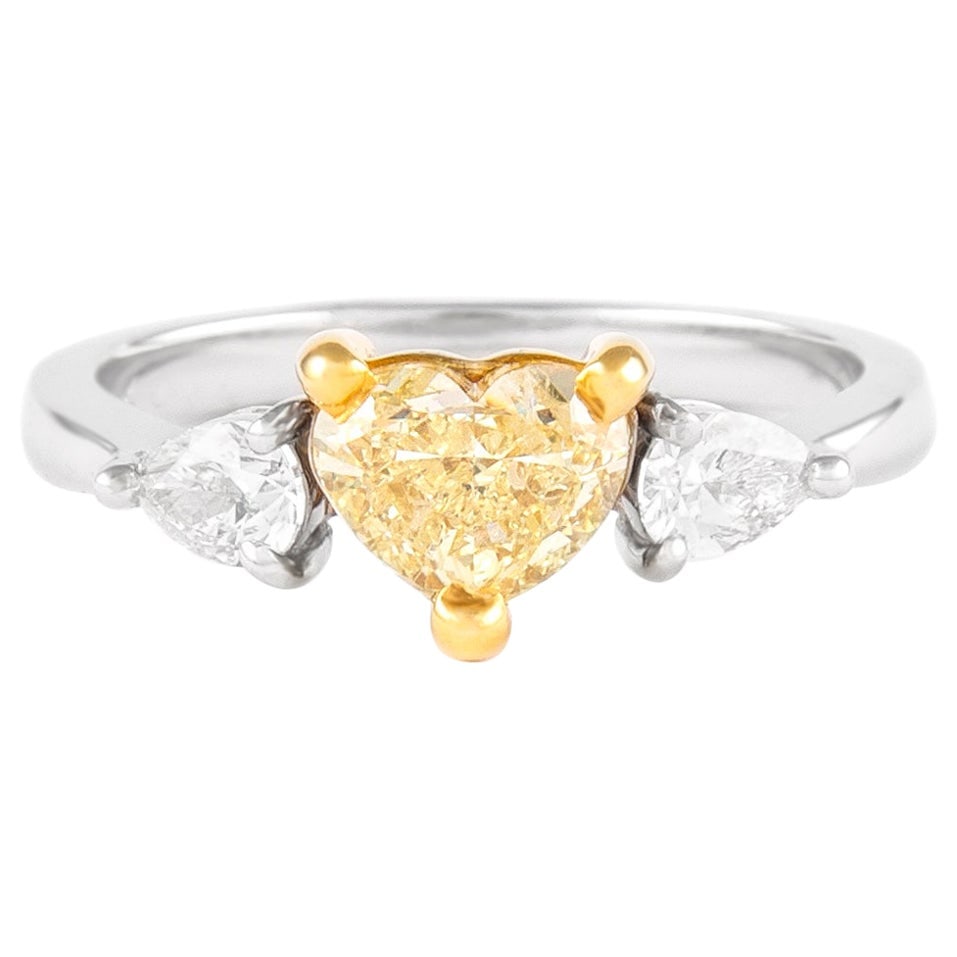GIA 1ct Fancy Yellow Diamond Three Stone Ring 18k Gold: GIA 1ct Fancy Yellow Diamond Three Stone Ring 18k Gold This exquisite three stone ring features a stunning GIA certified 1.00 carat Fancy Yellow diamond at its center, flanked by two pear-shaped diamo