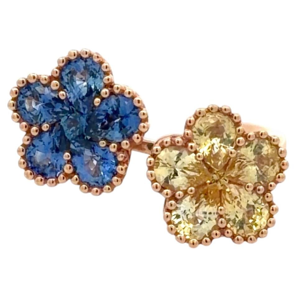 18K Rose Gold Double Flower Sapphire Ring 4.36 Carats: 18K Rose Gold Double Flower Sapphire Ring 4.36 Carats This contemporary double flower ring is crafted in 18K rose gold and features a vibrant arrangement of blue and yellow sapphires with a total cara
