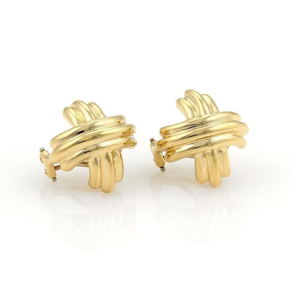 Tiffany & Co. 18k Yellow Gold X Crossover Huggie Earrings: Tiffany & Co. 18k Yellow Gold X Crossover Huggie Earrings This exquisite pair of earrings from Tiffany & Co. features a stylish X crossover design, expertly crafted in 18k yellow gold with a polished 