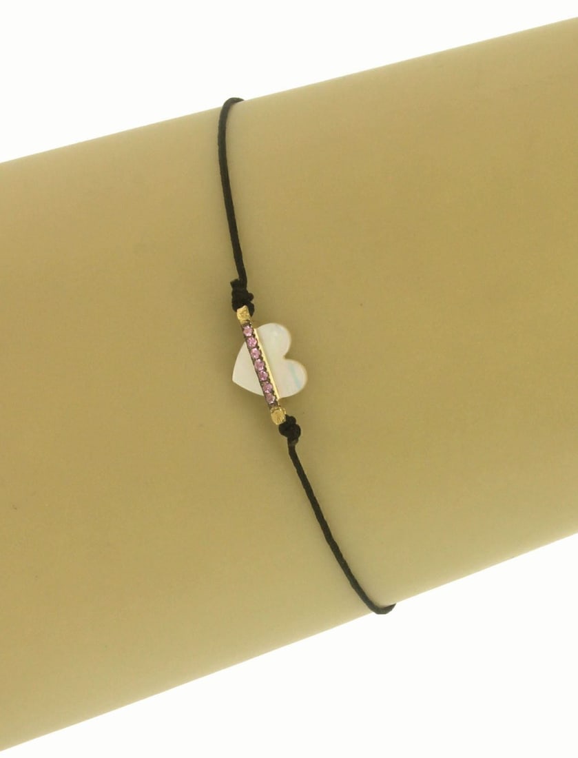 Victoria Casal 18k Yellow Gold Cord Bracelet Pink Sapphire Mother of Pearl Heart: Victoria Casal 18k Yellow Gold Cord Bracelet Pink Sapphire Mother of Pearl Heart This Victoria Casal bracelet features a delicate cord-style design crafted from 18k yellow gold. At its center is a lum