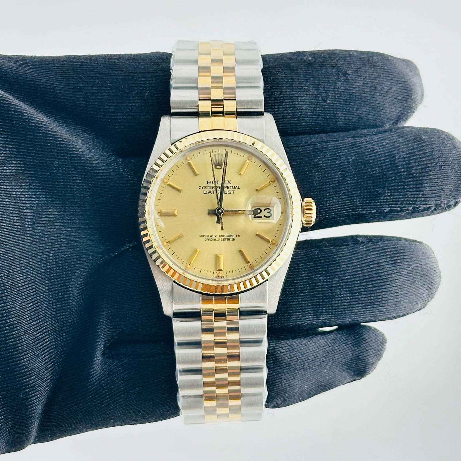 Rolex Datejust 16013 Champagne Stick Dial Aftermarket Jubilee Bracelet: Rolex Datejust 16013 Champagne Stick Dial Aftermarket Jubilee Bracelet This is a men's Rolex Datejust watch, reference number 16013, featuring a champagne stick dial and a fluted bezel. It comes fitte