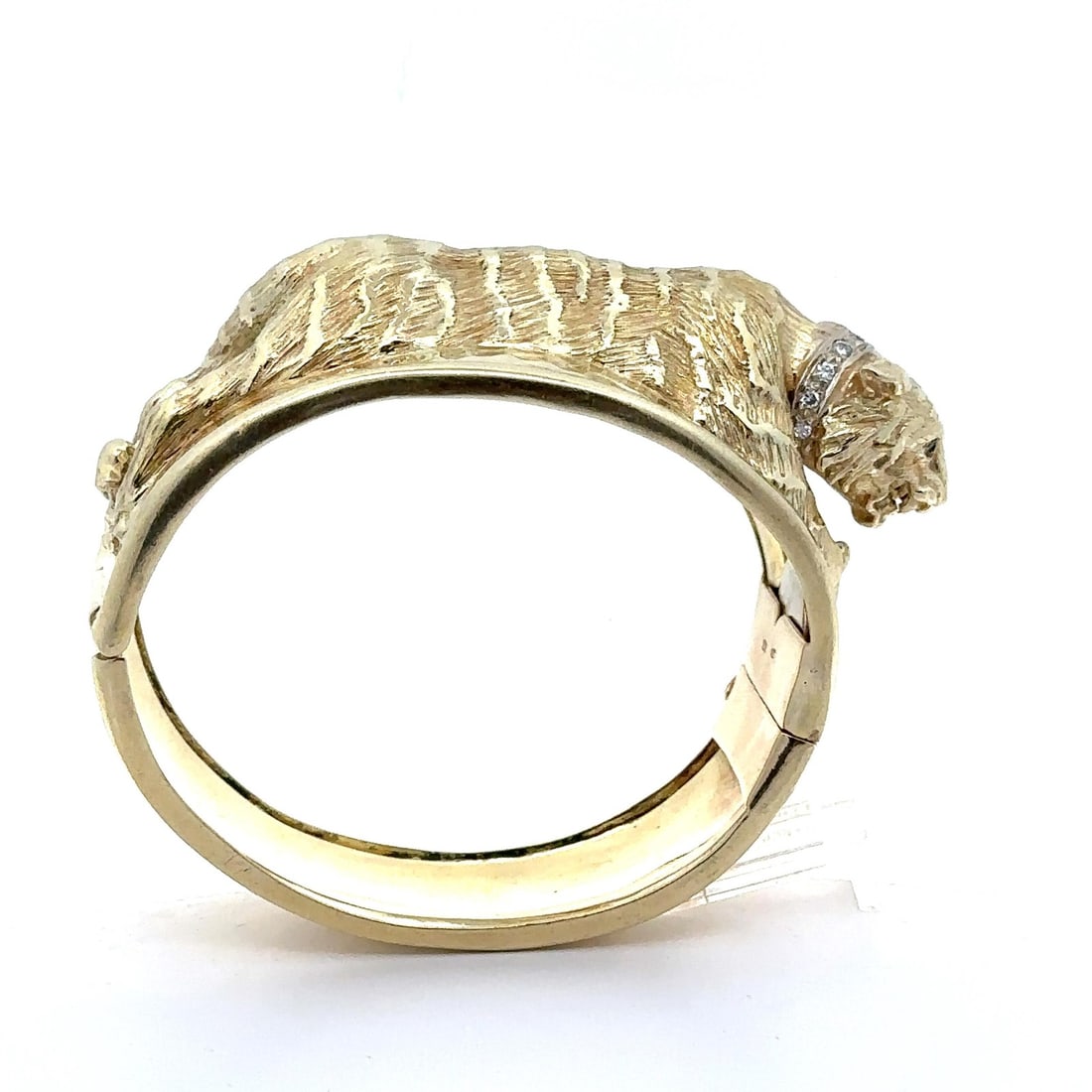 14k Solid Gold Tiger Bangle Bracelet with Diamond and Emerald Eyes: 14k Solid Gold Tiger Bangle Bracelet with Diamond and Emerald Eyes This stunning wide cuff bangle bracelet features a striking tiger design adorned with sparkling diamonds and vibrant emeralds. Crafte