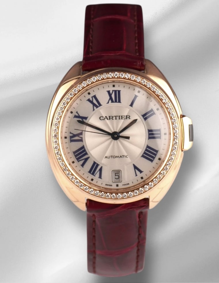 Ladies Cle Ref 3854 Maroon Strap Silver Roman Dial with Papers 2019: Ladies Cle Ref 3854 Maroon Strap Silver Roman Dial with Papers 2019 This Cartier Cle watch features a silver Roman numeral dial set within a bezel adorned with factory diamonds. The maroon leather bra
