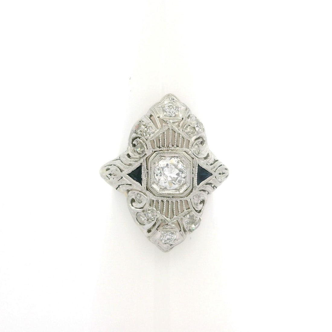Antique Art Deco Platinum Diamond Sapphire Filigree Ring 0.27ct Diamond: Antique Art Deco Platinum Diamond Sapphire Filigree Ring 0.27ct Diamond This exquisite Antique Art Deco ring showcases a stunning combination of diamonds and synthetic sapphires, beautifully highlight