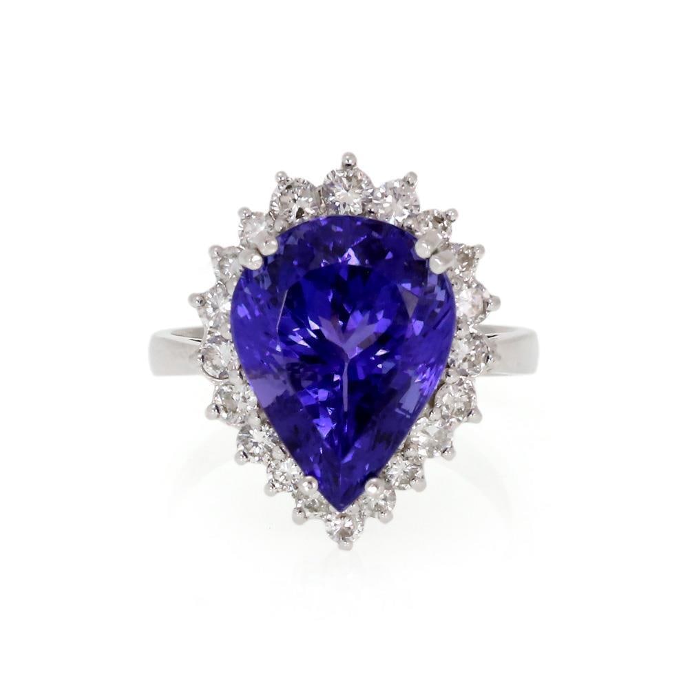 Stunning 14k White Gold 8ct Tanzanite Diamond Ring: Stunning 14k White Gold 8ct Tanzanite Diamond Ring This stunning cocktail ring showcases a large pear-shaped tanzanite gemstone weighing 8 carats, known for its intense color, elegantly framed in 14k 