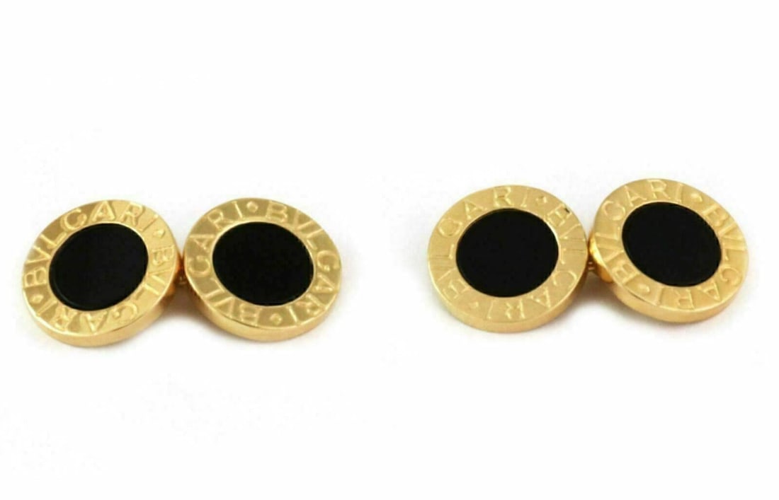 Bvlgari 18k Yellow Gold Onyx Chain Cufflinks: Bvlgari 18k Yellow Gold Onyx Chain Cufflinks These authentic Bvlgari double circle chain cufflinks are crafted from luxurious 18k yellow gold and feature elegant circular motifs accented by rich black