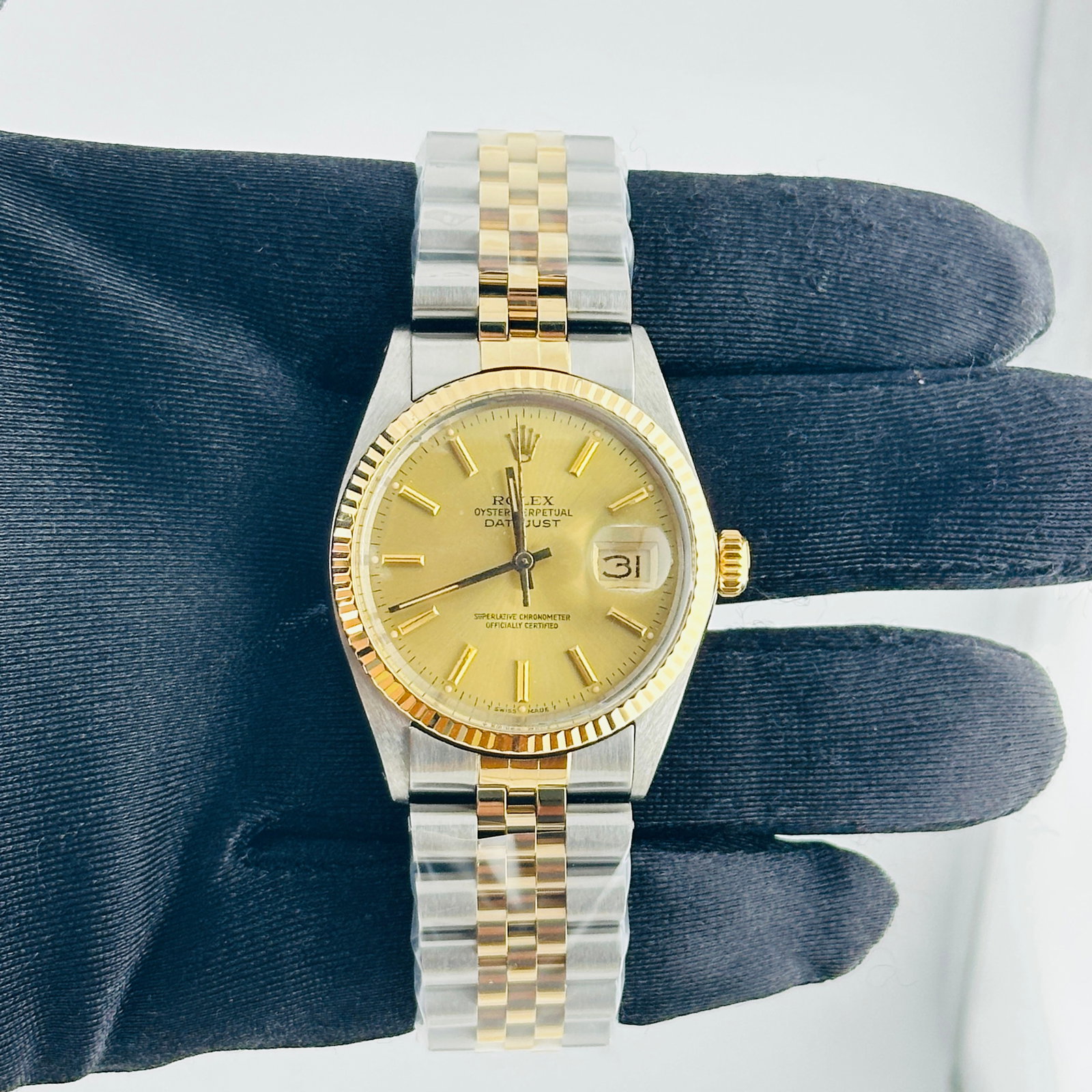 Rolex Datejust 16013 Champagne Stick Dial Aftermarket Jubilee Bracelet: Rolex Datejust 16013 Champagne Stick Dial Aftermarket Jubilee Bracelet This Rolex Datejust features a champagne stick dial and a fluted bezel, paired with an aftermarket Jubilee bracelet. The watch is