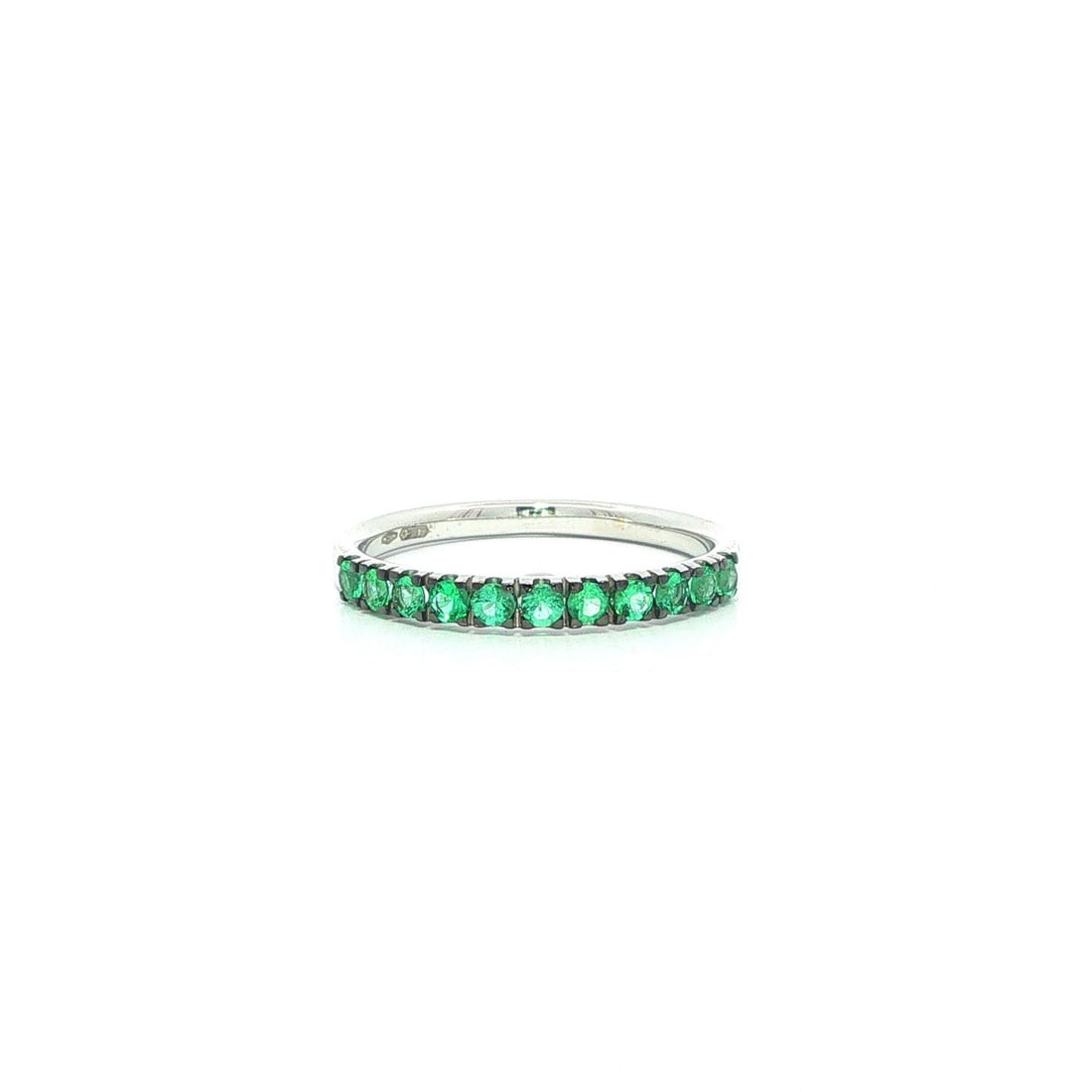 Emerald pave band ring in 18k white gold with black rhodium top size 6.5: Emerald pave band ring in 18k white gold with black rhodium top size 6.5 This unbranded women's band ring features numerous natural, round brilliant cut emeralds with a total carat weight of 0.40, set
