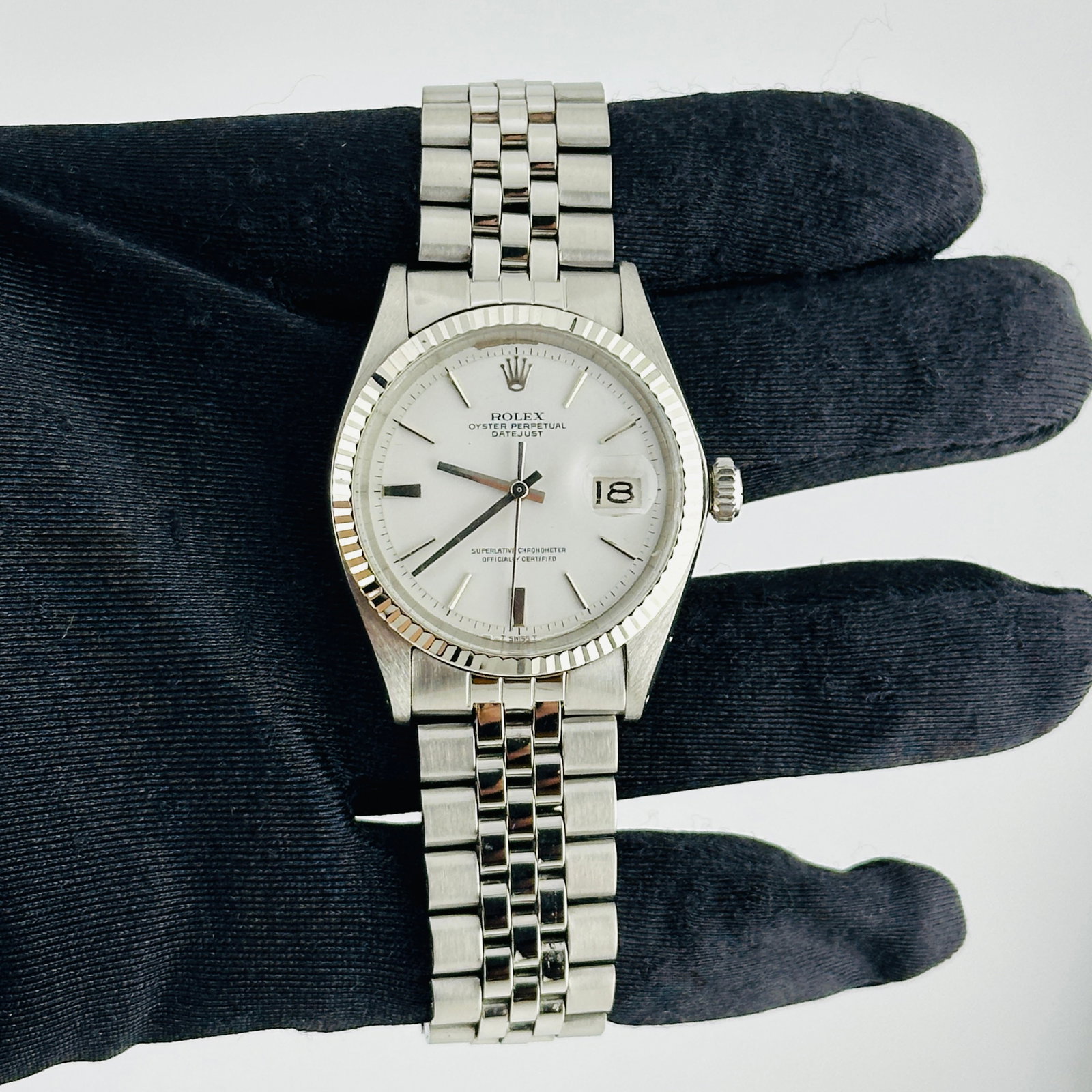 Rolex Datejust 1601 White Refinished Dial Fluted Bezel Jubilee Bracelet: Rolex Datejust 1601 White Refinished Dial Fluted Bezel Jubilee Bracelet This Rolex Datejust features a white stick dial, fluted bezel, and a folded Jubilee bracelet. It is a men's watch with reference