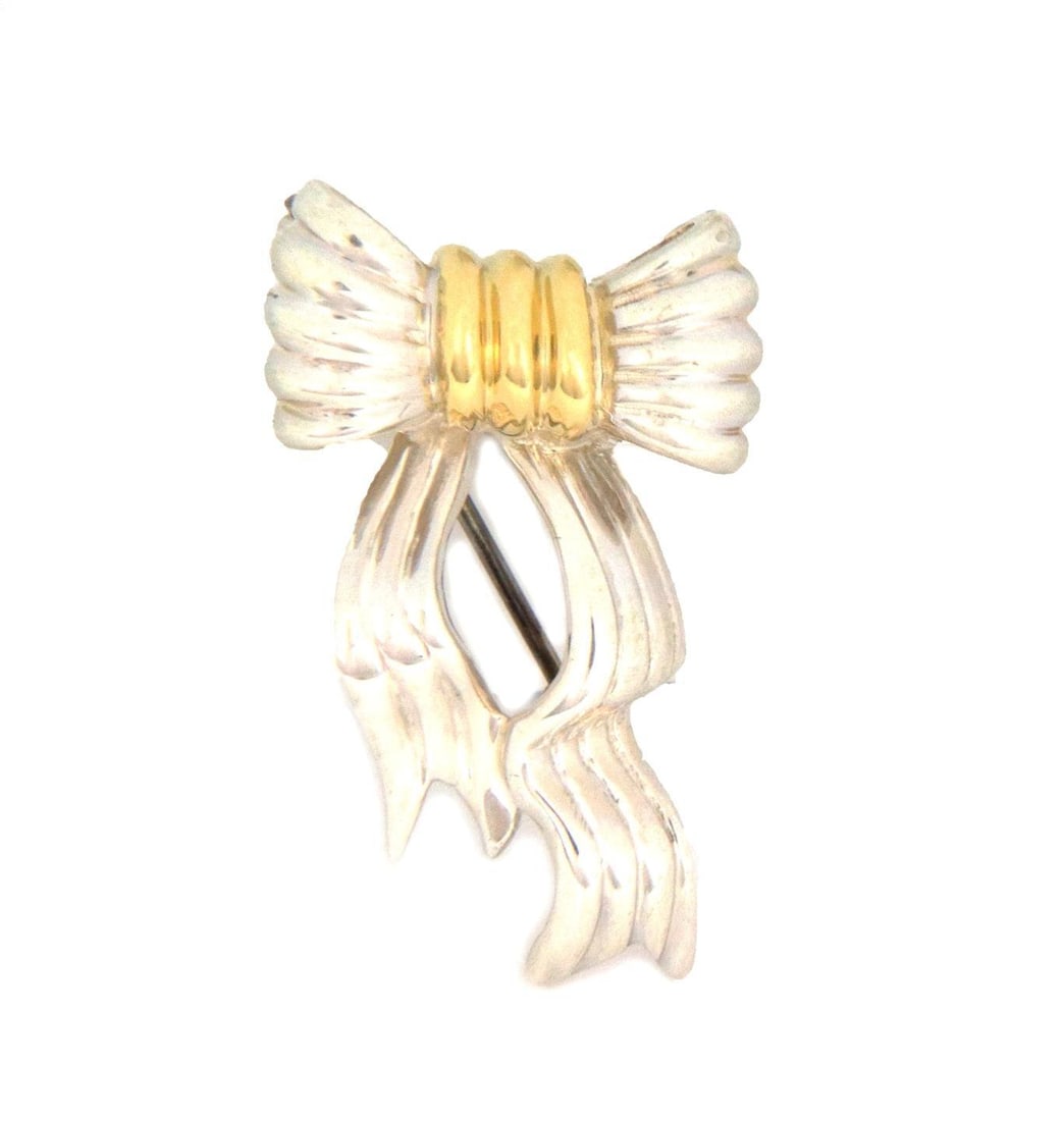 Tiffany & Co. Vintage Bow Brooch in Sterling Silver 18k Yellow Gold: Tiffany & Co. Vintage Bow Brooch in Sterling Silver 18k Yellow Gold Introducing a stunning vintage brooch by Tiffany & Co., expertly crafted from sterling silver and accented with 18k yellow gold. Thi