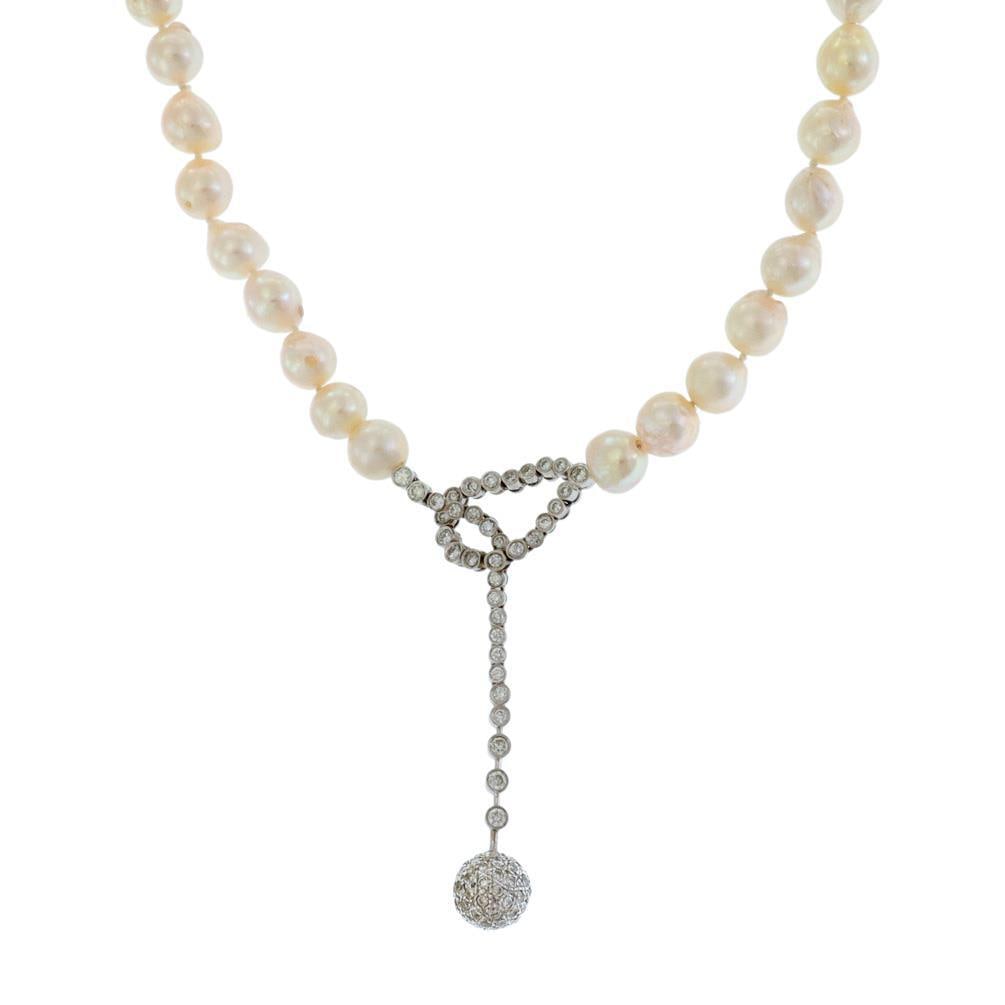 Stunning 1.70ct Diamond Baroque Pearl 18k White Gold Pendant Necklace: Stunning 1.70ct Diamond Baroque Pearl 18k White Gold Pendant Necklace This exquisite vintage necklace features a stunning long dangle knot style pendant made from 18k white gold. The pendant showcases