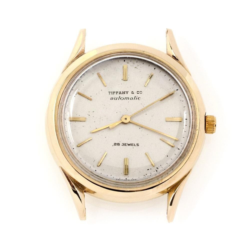 Tiffany & Co. Vintage 14k Yellow Gold Men's Watch 34.5mm: Tiffany & Co. Vintage 14k Yellow Gold Men's Watch 34.5mm This exquisite Tiffany & Co. wrist watch features a case made of 14k yellow gold, showcasing a classic 34.5mm round shape. The watch is designe