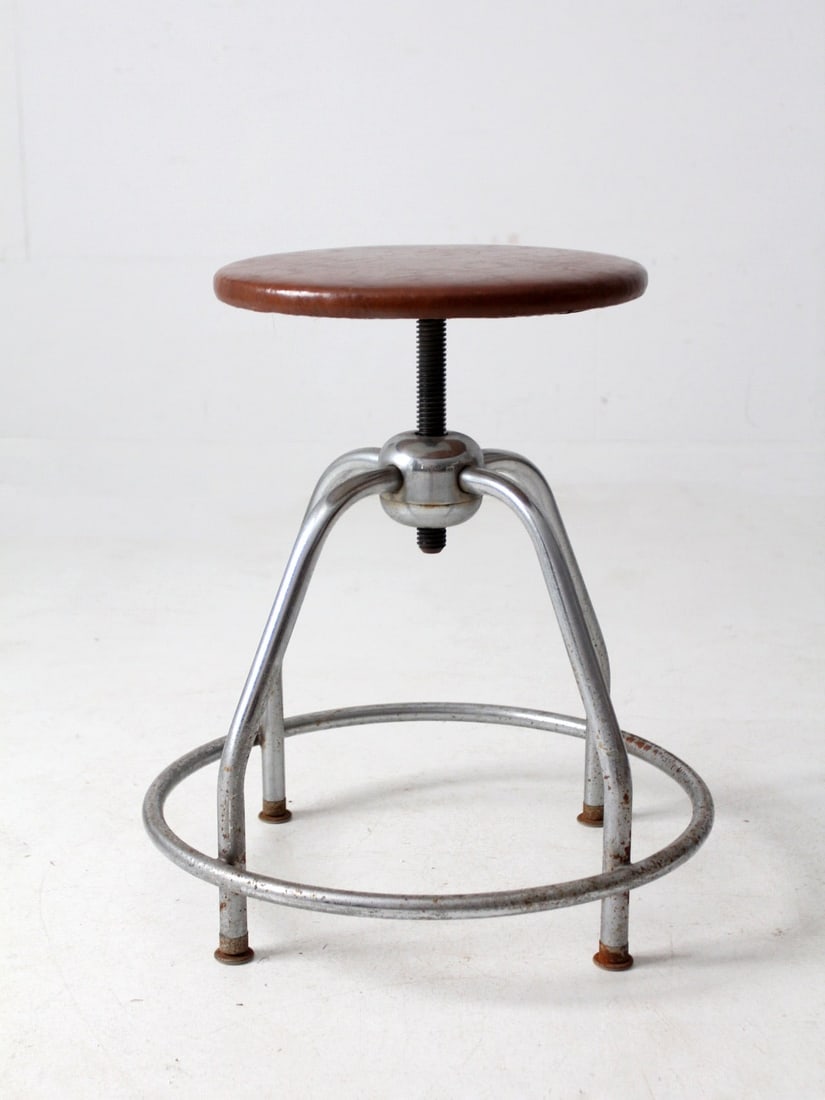 Vintage Mid Century Umf Swivel Stool with Chrome Frame: Vintage Mid Century Umf Swivel Stool with Chrome Frame This vintage United Metal Fabricators stool embodies the essence of mid-century industrial design. Featuring a chrome-plated steel frame, this sw