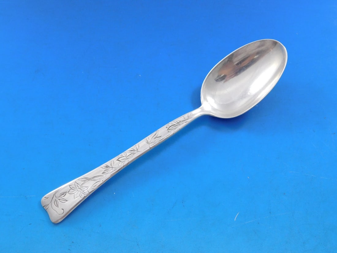 Tiffany & Co. Sterling Silver Teaspoon Lap Over Edge Poinsettia 6": Tiffany & Co. Sterling Silver Teaspoon Lap Over Edge Poinsettia 6" This exquisite teaspoon from Tiffany & Co. features the elegant Lap Over Edge pattern, adorned with intricate acid-etched poinsettia 