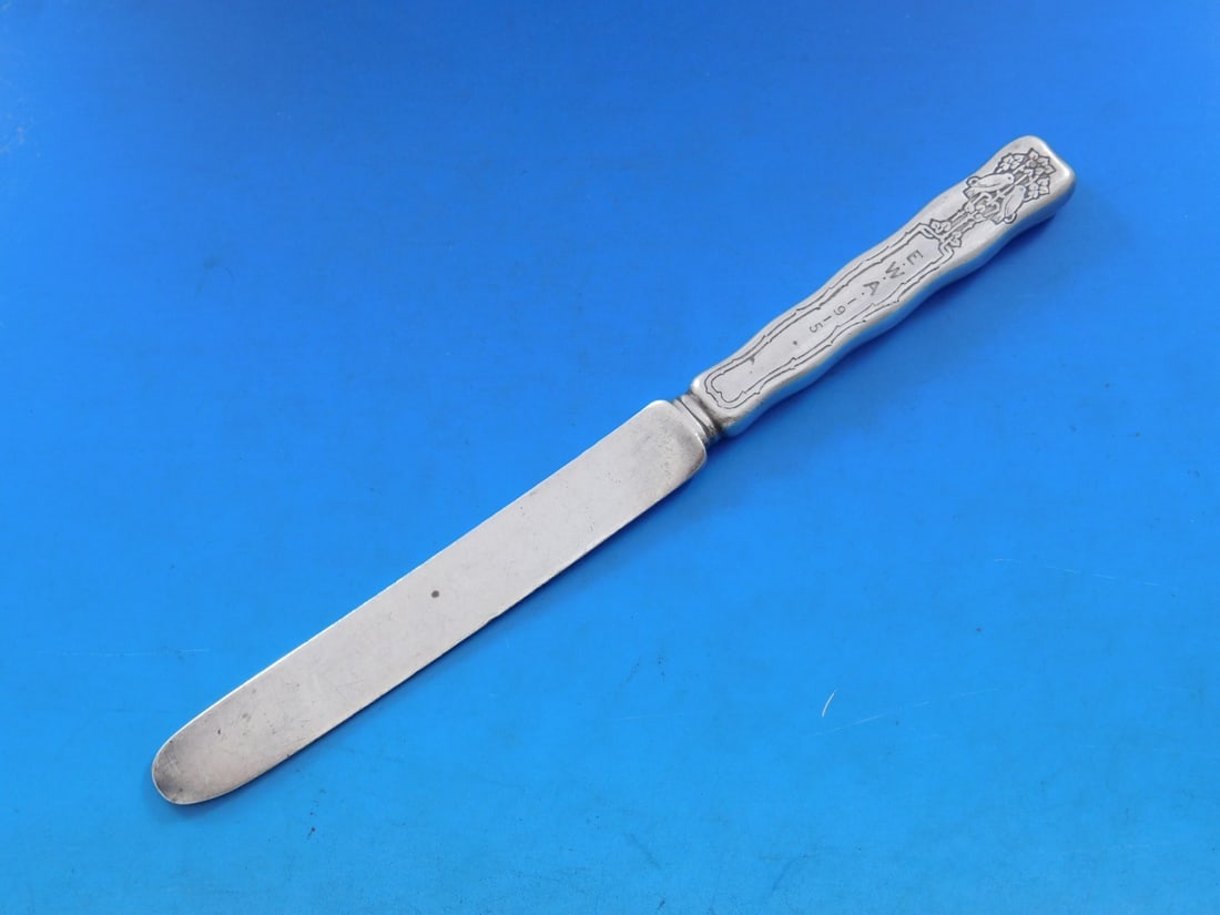 Tiffany Sterling Silver Lap Over Edge Dessert Knife Love Birds 7.5": Tiffany Sterling Silver Lap Over Edge Dessert Knife Love Birds 7.5" This exquisite dessert knife is a remarkable piece from Tiffany & Co., featuring the elegant Lap Over Edge pattern. Crafted from ste