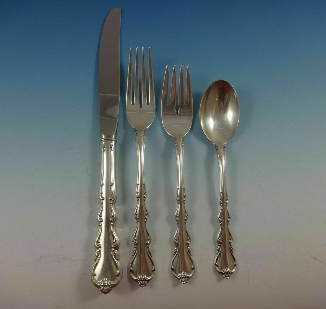 International Angelique Sterling Silver 4pc Place Setting: International Angelique Sterling Silver 4pc Place Setting Elevate your dining experience with the Angelique by International Sterling Silver 4-piece regular size place setting. This exquisite set embo