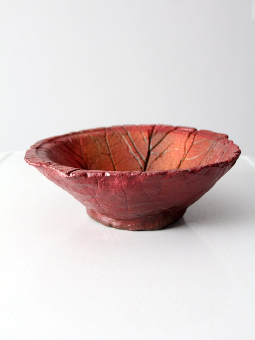 Handmade Vintage Studio Pottery Leaf Bowl Red Glaze 14": Handmade Vintage Studio Pottery Leaf Bowl Red Glaze 14" This vintage studio pottery leaf bowl is a stunning addition to any collection. Handmade with an intricate leaf imprint, it features a striking 