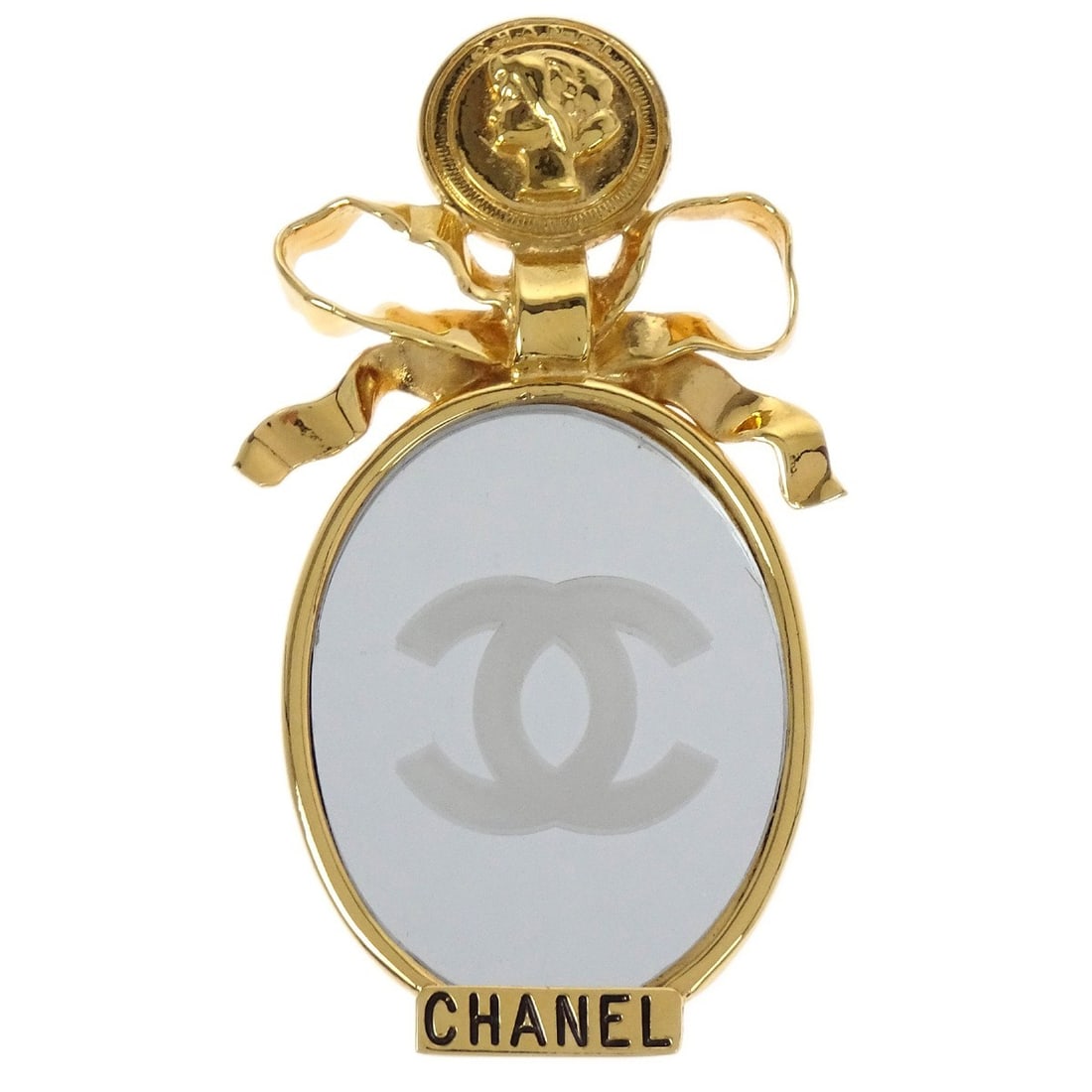 CHANEL gold plated bow motif brooch pin with box: CHANEL gold plated bow motif brooch pin with box Chanel bow mirror motif brooch pin in gold-plated metal. This brooch features a ribbon-inspired design with an oval mirror motif and comes with its box