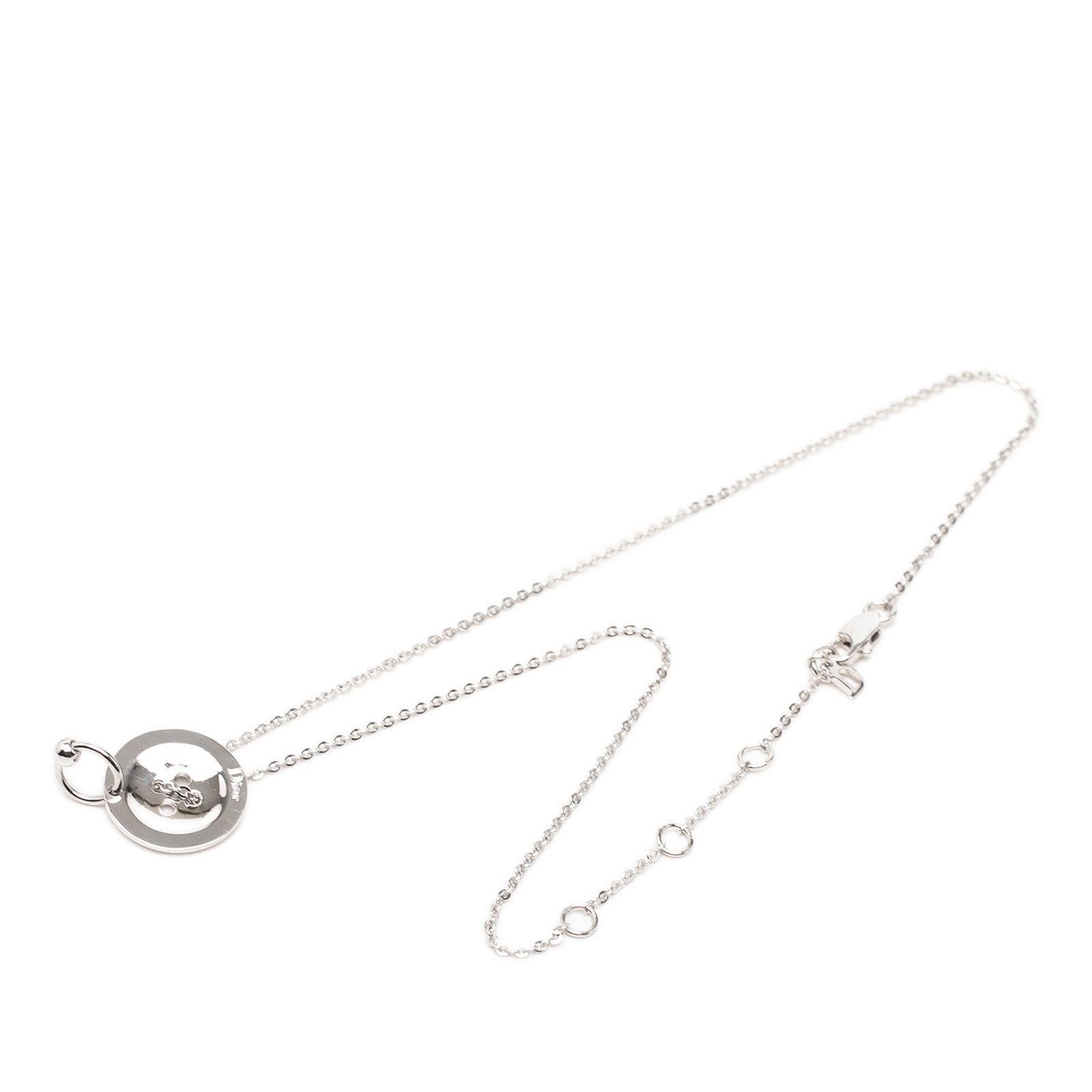 Dior Brass Button Pendant Silver Plated Necklace: Dior Brass Button Pendant Silver Plated Necklace Dior Brass Button Pendant Necklace crafted in silver plated metal with a button-style pendant and lobster clasp closure. This costume jewelry piece is 