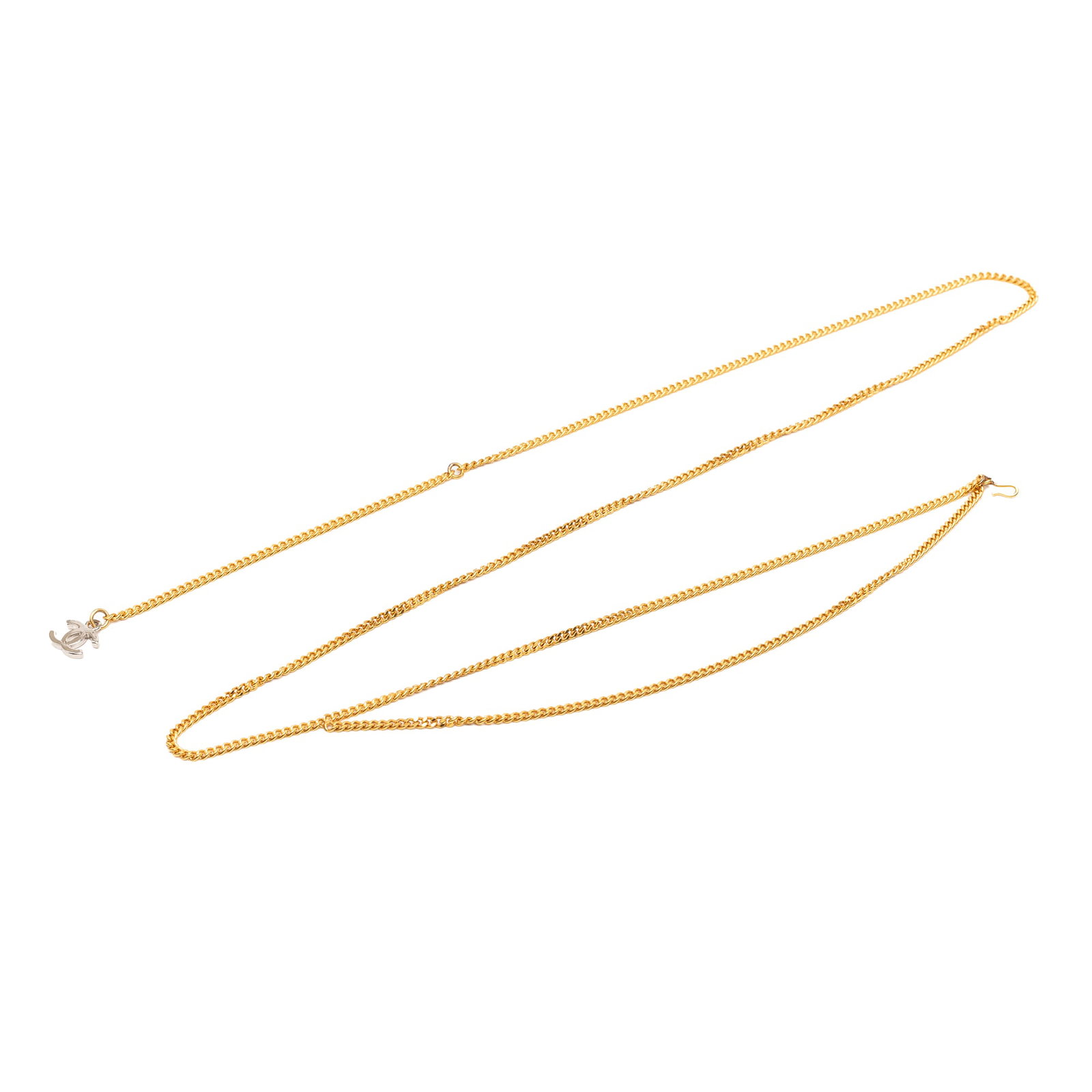 Chanel CC Gold Tone Chain Belt with Brass Charm: Chanel CC Gold Tone Chain Belt with Brass Charm Chanel CC chain belt with a gold-tone metal body, a silver-tone brass CC charm, and a hook closure. Made in France. Condition is B+ with scratches noted