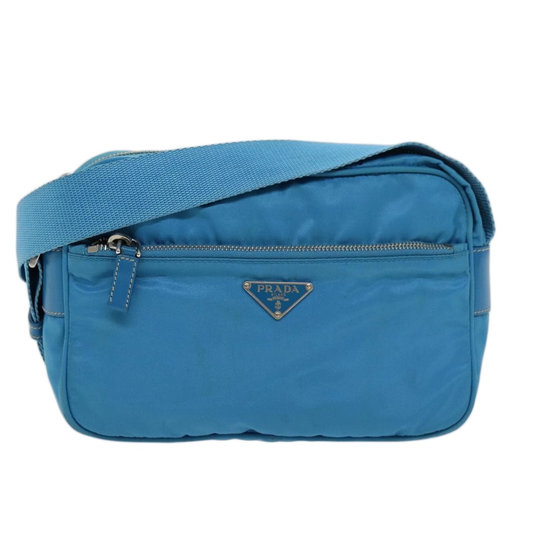 PRADA Nylon Shoulder Bag Light Blue with Dust Bag: PRADA Nylon Shoulder Bag Light Blue with Dust Bag Authentic Prada shoulder bag in light blue nylon with a compact silhouette and adjustable shoulder strap. Includes a dust bag. Made in Italy. Conditio