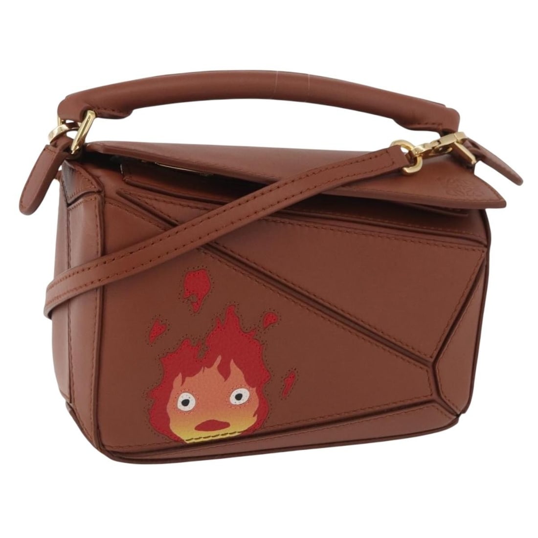 LOEWE Studio Ghibli Calcifer Mini Puzzle 2way Leather Hand Bag: LOEWE Studio Ghibli Calcifer Mini Puzzle 2way Leather Hand Bag LOEWE x Studio Ghibli Calcifer Puzzle mini 2-way handbag crafted in leather with a brown and gold colorway. Made in Spain, this women's b