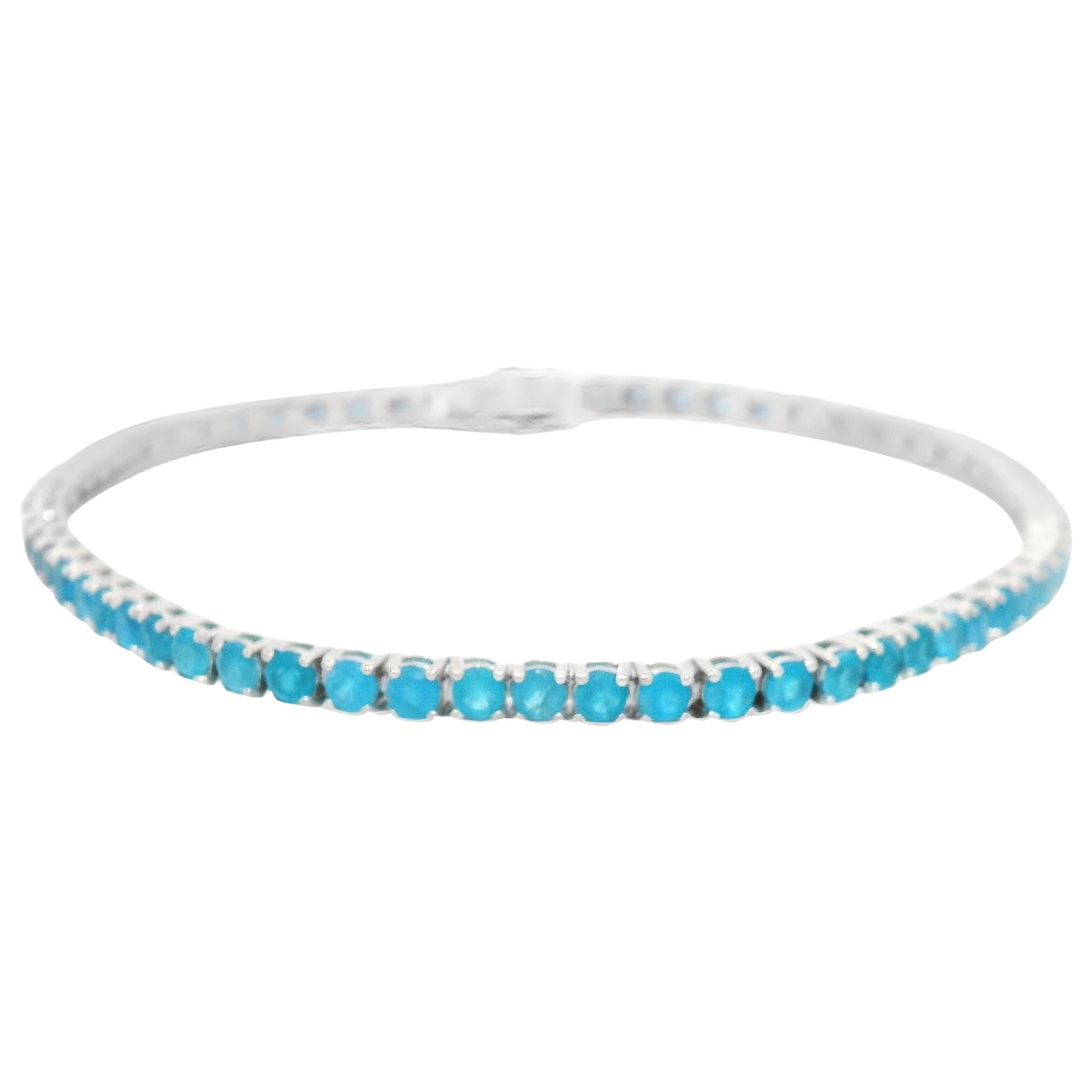 4.91ct Blue Apatite Tennis Bracelet 18k White Gold GIA Appraised: 4.91ct Blue Apatite Tennis Bracelet 18k White Gold GIA Appraised This stunning tennis bracelet features a total of 4.91 carats of vivid blue apatite, reminiscent of the vibrant hues of paraiba tourmal