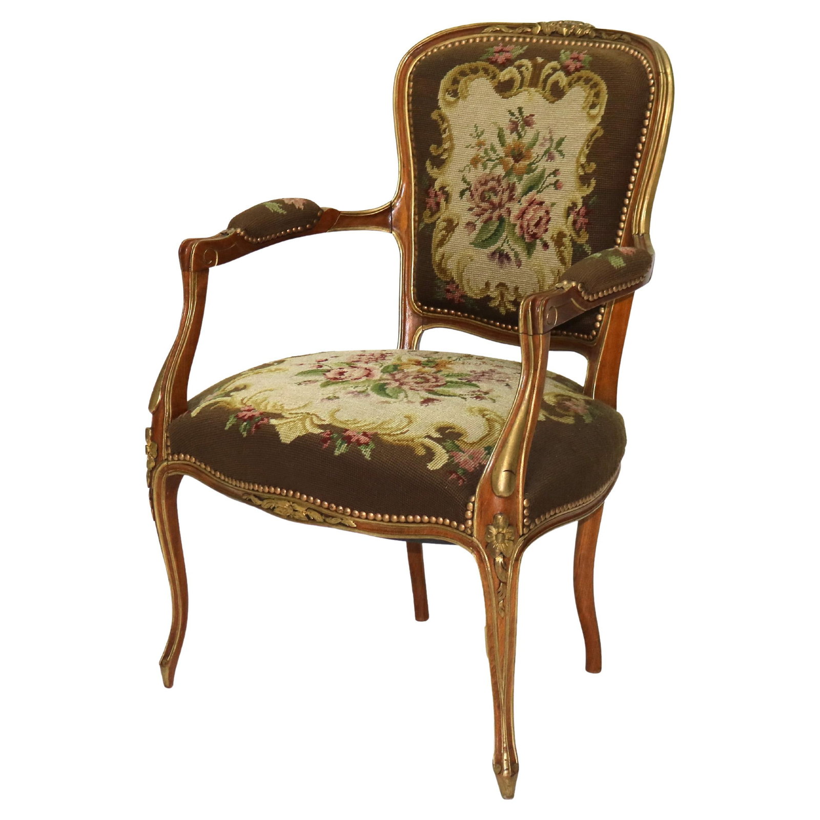 Louis XIV Style French Armchair Parcel Gilt Walnut Floral Tapestry c1920: Louis XIV Style French Armchair Parcel Gilt Walnut Floral Tapestry c1920 This early 20th-century parlor chair is crafted in the French Louis XIV style, dating to circa 1920. It features a carved walnu