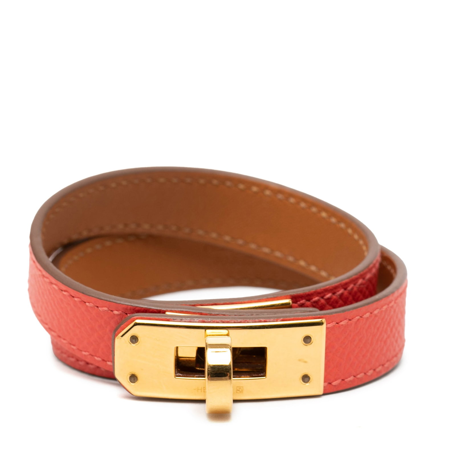 Hermes Kelly Double Tour Leather Bracelet Orange: Hermes Kelly Double Tour Leather Bracelet Orange Hermes Kelly Double Tour bracelet crafted in orange leather with gold-plated hardware and a turn-lock closure. This costume jewelry piece is made in Fr